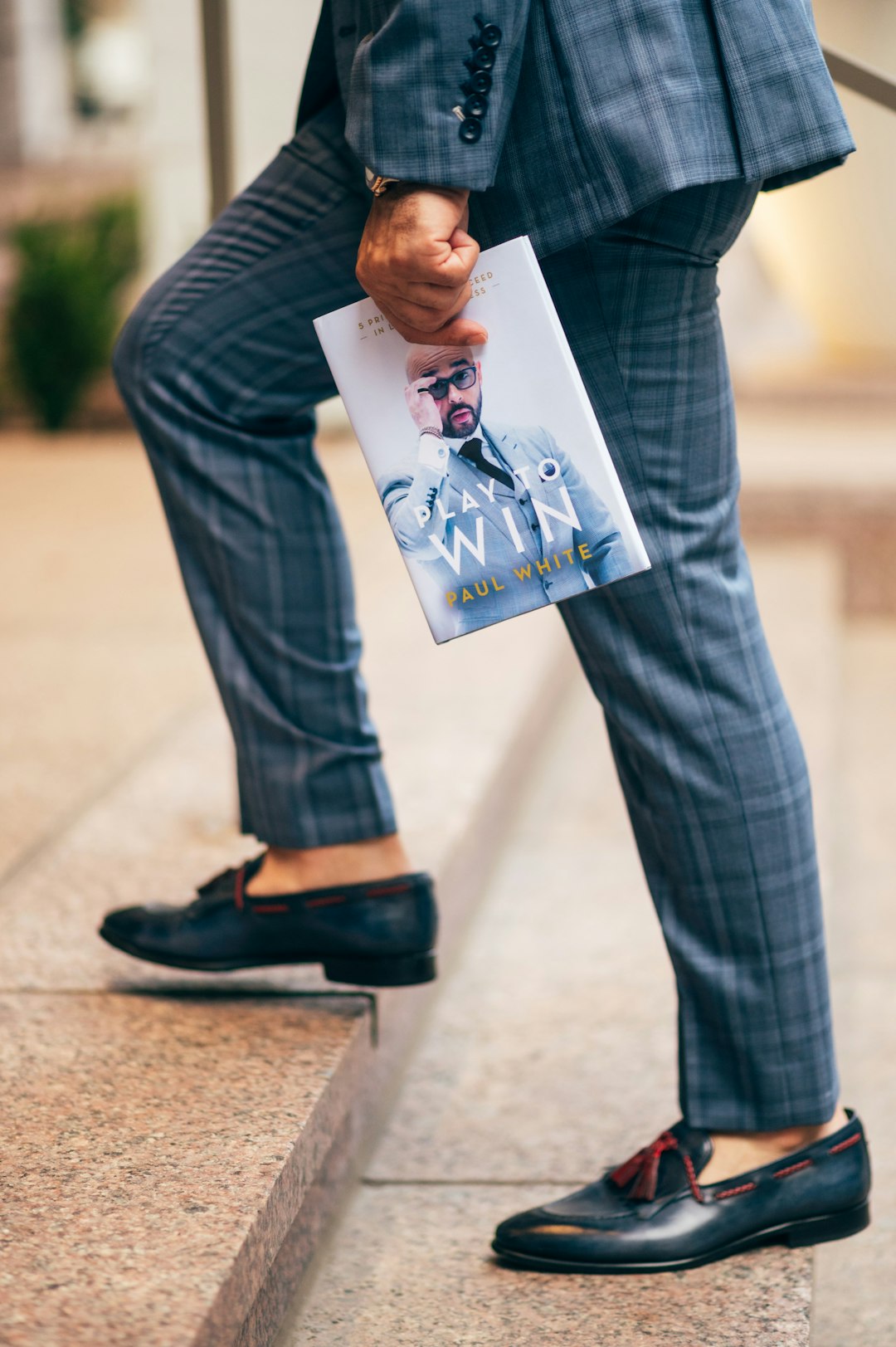 man-in-black-long-sleeve-shirt-and-blue-denim-jeans-holding-a-book-0o8uqc9qsvm
